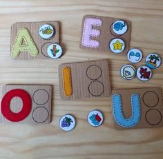 the letters are made out of cardboard and have magnets attached to them on a wooden surface