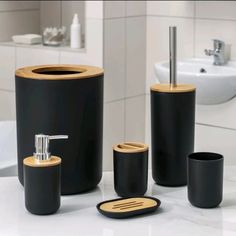 black and gold bathroom accessories are on the counter