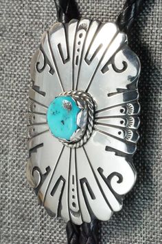 This turquoise and sterling silver bolo tie was made by Navajo silversmith Rosita Singer. The back is signed T&R Singer and stamped sterling.Tie Length: 22"Length: 2 3/8"Width: 1 3/4"Tips:Length: 2 1/8"Width: 1/4"Free shipping on all orders! We ship with USPS and always include tracking. All orders ship within a day of payment.Returns are accepted up to 30 days after you receive your order. Just send us a message. Our shop offers cash back or store credit. The item must be returned in new condit Western Silver Turquoise Necklace With Concho, Southwestern Sterling Silver Bolo Tie, Southwestern Style Sterling Silver Bolo Tie, Bolo Tie, Turquoise Sterling Silver, Turquoise Ring, Turquoise Bracelet, Washer Necklace, Turquoise