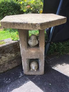 a stone table with two cats in it