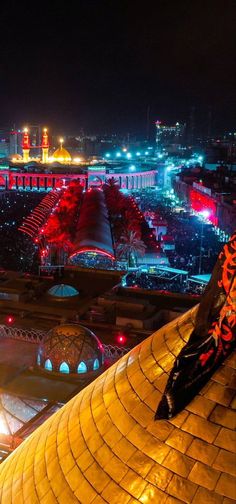 an aerial view of a city at night, with lights and buildings in the background