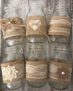 six mason jars with lace and burlocks