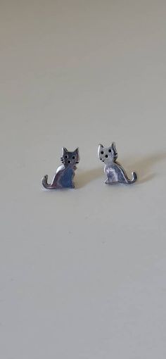 These are one of the cutest pairs of earrings I've ever seen. If you're a cat lover, animal lover, or love cute jewelry, these are perfect for you!  They only measure about 1 CM long. They are so sweet. They are marked 925 on the back and are posts or stud earrings. They have the original sterling backs as well. They are from about the late 1990's or early 2000's. If you have anymore questions about these cute earrings, please message me! They make a perfect little gift. Cat Stud Earrings, Cat Earrings Studs, Silver Cat, Sterling Silver Stud Earrings, Silver Stud Earrings, Sterling Silver Studs, Sterling Silver Earrings Studs, Cute Earrings, Silver Earrings Studs