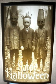 an old photo of two children with creepy faces on their heads and the words happy halloween written in white