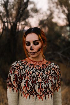 a woman with makeup painted to look like a skeleton