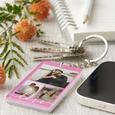 a cell phone and keychain sitting on a table