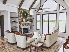 a living room filled with furniture and a fire place next to a wall mounted tv