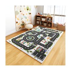 a child's play area with toy cars and roads on the rug in front of it