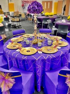 purple and gold table cloths are set up for an event