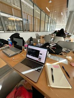 an open laptop computer sitting on top of a wooden desk