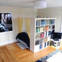 a bedroom with bookshelves and a bed in it