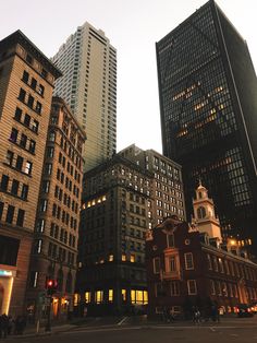 several tall buildings are lit up at night