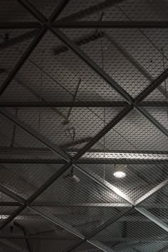 the ceiling is covered with metal mesh and lights are hanging from it's sides