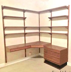 an empty room with some shelves and drawers