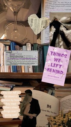 a book shelf filled with lots of books next to a wine glass and chess board