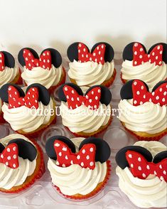 mickey mouse cupcakes with white frosting and red bows