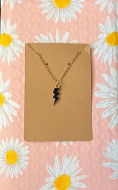 This is a lightning bolt chained necklace worn around the neck. Edgy Gold Necklace For Gifts, Edgy Gold Necklace For Gift, Edgy Adjustable Chain Necklace For Gifts, Gold Lightning Bolt Jewelry Gift, Gold Lightning Bolt Jewelry For Gift, Lightning Bolt Jewelry, Chained Necklace, Necklaces Gold, Spring Set