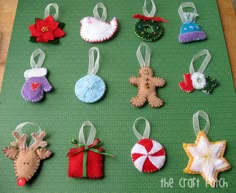 christmas ornaments are arranged on a green mat