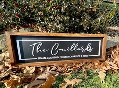 a black and white sign that says the cadillacs on it in front of some leaves