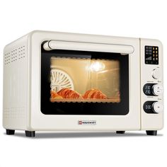 a white toaster oven with some food in it's door and light on