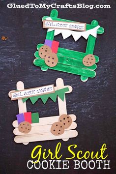 two paper crafts made to look like alligators with cookies on them and the words girl scout