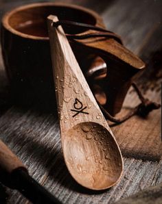 two wooden spoons sitting on top of a table