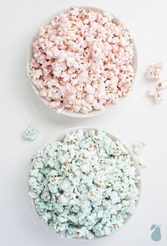 two bowls filled with popcorn sitting next to each other on top of a white table