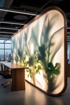 an office with a plant on the wall in front of it's desks