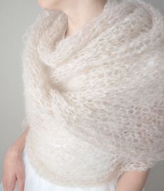 a woman wearing a white knitted shawl