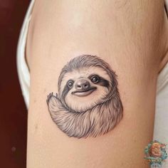 a sloth tattoo on the thigh