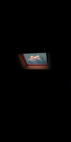 the sky is very dark and there are clouds in the window sill above it