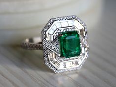 Natural Emerald Art Deco engagement ring, Antique engagement ring, 2.5 carat Emerald cut, Diamond baguette halo engagement ring This unique emerald ring comes with 2.5 carat Emerald and is surrounded by diamonds is made for special occasions! Same design can be made also with other custom gemstones per request. Product details: - 14k or 18k Solid gold - approx. 2.5 carats Genuine Great quality emerald with a certificate of authenticity. - approx. 1.22 carats genuine G VS-SI diamonds - Made to or Art Deco Emerald Ring With Diamond Accents As Gift, Art Deco Emerald Rings With Diamond Accents, Art Deco Gia Certified Emerald Ring As Gift, Gia Certified Art Deco Emerald Ring Gift, Art Deco Emerald Ring With Halo Setting, Gia Certified Art Deco Emerald Ring, Gia Certified Art Deco Jewelry For Anniversary, Art Deco Gia Certified Jewelry For Anniversary, Art Deco Emerald Ring With Halo Setting For Anniversary