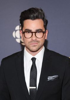 a man in a suit and tie wearing glasses