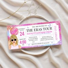 a ticket to the eras tour is shown on a white surface with pink and purple confetti