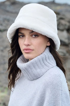 Warm up in an instant with the Shearling Sheepskin Bucket Hat—lending a heaven-sent texture to a timeless style. This hat’s plush Spanish sheepskin mouton exterior effortlessly elevates your winter look while keeping you snug and warm. Boasting a flared brim that hugs your face in velvety softness, this charming and cozy hat will shield you from the elements all day and right into the evening. Finished with a poly satin lining. Fur Hat Outfit, Hats Cowboy, Bucket Hat Outfit, Country Hats, Fur Hats, Brim Hats, Cozy Hat, Sheepskin Coat, Trapper Hats