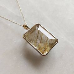 ITEM DESCRIPTION: >>The pendant is made from Solid 14K Yellow Gold. Gemstone used is absolutely natural and ethically sourced. >>Natural Golden Rutile in crafted bezel setting is studded on it with utmost precision. >>This is a minimalist design and is absolutely hassle-free and everyday jewelry. Gem: Golden Rutile Gem size: 18x23.5mm Gem weight: 35.00 carats Gold purity: 14K (58.33% approx.) Gold weight: 3.43 grams Gross weight: 10.43 grams The Gold purity is guaranteed and it comes with authen Diamond Large Pendant Jewelry Gift, Gold Jewelry With Rectangular Polished Stone, Gold Jewelry With Polished Finish And Rectangular Stone, Gold Sterling Silver Necklace With Rectangular Stone, 14k Gold Jewelry With Large Pendant For Gift, 14k Gold Large Pendant Jewelry Gift, Yellow Gold Necklace With Rectangular Stone For Anniversary, Fine Jewelry Rectangular Pendant With Diamond Cut, Fine Jewelry With Diamond Cut Rectangular Pendant