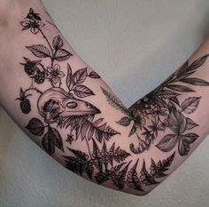 a woman's arm with flowers and birds on it