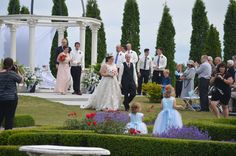 a bride and groom walking down the aisle