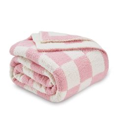 the pink and white checkered blanket is folded up