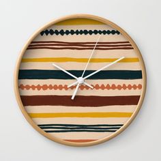 a clock that is on the side of a wall with different colors and lines in it