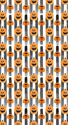 an orange and black striped background with jack - o'- lantern faces on it