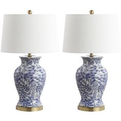 two blue and white vases with lamps on them