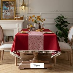 a dining room table covered with a red tablecloth