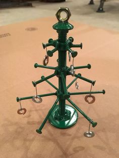 a green metal device with multiple parts attached to it