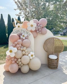 balloons and flowers are on display in front of a chair