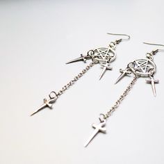 These dark and alluring Dagger Earrings. Measuring 3.5 inches in length, these alloyed earrings are perfect for adding a touch of edgy style to any outfit. Make a statement and stand out from the crowd with this must-have accessory. Edgy Pierced Metal Earrings, Edgy Metal Earrings With Ear Wire, Edgy Nickel-free Dangle Plug Earrings, Gothic Dangle Metal Plug Earrings, Gothic Metal Dangle Plug Earrings, Punk Style Metal Dangle Hoop Earrings, Edgy Metal Drop Plug Earrings, Gothic Metal Plug Earrings With Ear Wire, Punk Style Metal Jewelry With Ear Wire