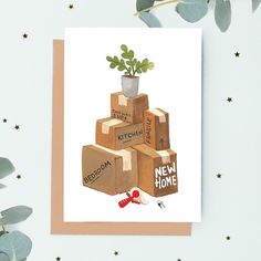 a card with a potted plant sitting on top of boxes that say new home