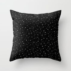 a black and white pillow with stars in the night sky on it's side