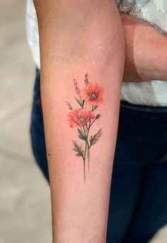 a woman with a flower tattoo on her arm