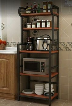 a microwave oven sitting on top of a wooden shelf in a kitchen next to a counter